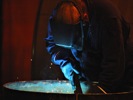 A Boilermaker MIG welding the inside of a package boiler, Bryan Steam, Peru, Indiana