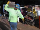 Worker carrying a keel block at the launch of the USS McLean, NASSCO Shipyards, National City, California, 2011