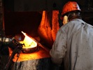 An expert forger working a ten thousand pound forge hammer at Portland Forge, Indiana, 2011