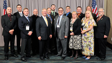 REP. DENNY HECK (D-WA-10th), center, gray suit, with IP Newton Jones, fifth from left; IR Gary Powers, third from left; retired IR Dave Bunch, far right; and Western States delegates from Local 104, Local 242,and Local 290.