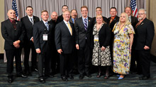 REP. DEREK KILMER (D-WA-6th), center, striped tie, with IP Newton Jones, fifth from left; IR Gary Powers, third from left; retired IR Dave Bunch, far right; and West-ern States delegates from Local 104, Local 242,and Local 290.