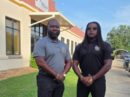 Edwin Allen (left) and Carlos Brooks (right) get ready to talk to workers at Trojan Battery in Sandersville, Georgia