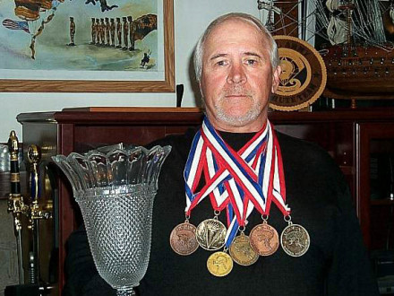 L-154’s John Heine-Parisi shows some of the medals he has won over his 40-year skydiving career.