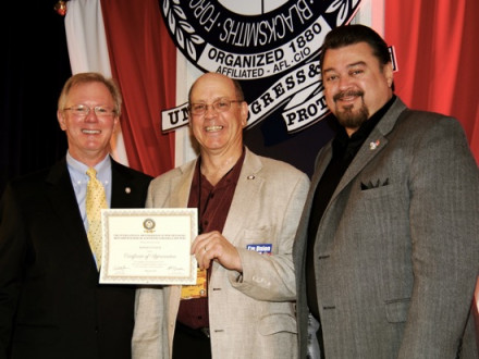 L-11 President Robert Winger (c.) receives an award from IP Newton Jones, left, with IVP J. Tom Baca at right.