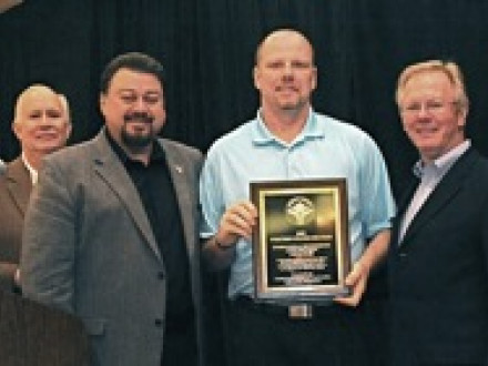 Local 500 (Salem, Ore.) BM-ST Darin McCarthy accepts the national NACBE safety award. Joining in the presentation are, l. to r., NACBE Exec. Dir. John Erickson, IVP J. Tom Baca, McCarthy, and IP Newton Jones.