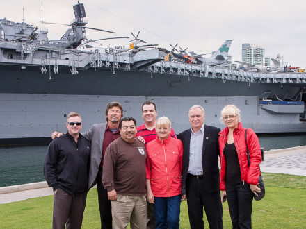 Ukrainian visitors to L-1998 enjoy a close-up view of the USS Midway aircraft carrier. Left to right, Gary Powers, A/D-ISO; Jim Cooksey, IR; Bobby Godinez, L-1998 president; Tyler Brown, D-ISO/AAIP; Liubov Nyemov; Anatoliy Nyemov, chairman of the Okean Shipyard trade union; and Oksana Kovalka, interpreter.