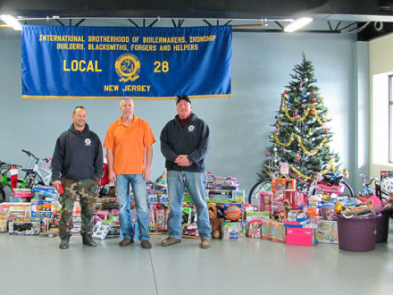 TAKING PART IN THE L-28 TOYS FOR TOTS DRIVE are l. to r., steward Robert Haslach, President Bob Flynn, and steward Wayne Van Wagner.