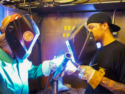 Engineer graduate Alicia Crass, Kiewit, receives welding instruction from L-83 apprentice Steve Ryken.