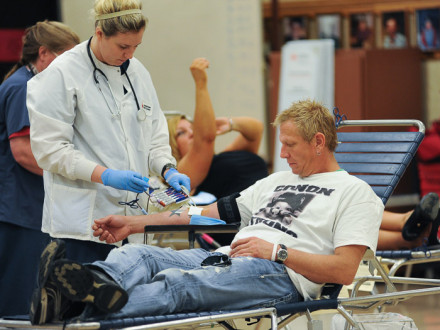 Red Cross Worker Pennie Rockhold collects blood from Kris Kennedy during the drive.