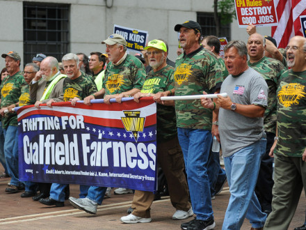 IVP Dave Haggerty, far right in gray shirt, marches on the front line with UMWA officers.