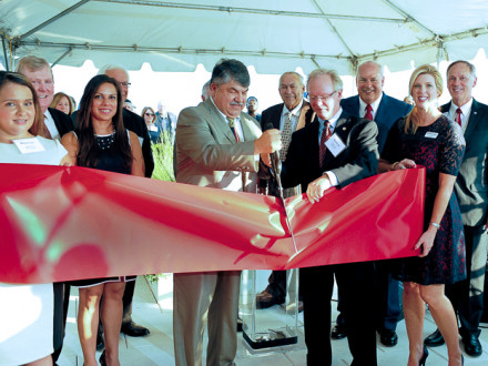 AFL-CIO President Richard Trumka, with scissors, and Bank of Labor (BOL) Chairman and CEO Newton Jones, standing with Trumka, cut the ribbon to officially open the bank’s new Washington, D.C., office. Joining in the ceremony are, l. to r., Megan Elder, BOL Marketing Development Officer; Bob McCall, BOL President; Puja Arora, COO, AFL-CIO ITC; Jack Marco, Chairman, Marco Consulting Group (partially hidden); Patrick Finley, General President, OPCMIA; Ed Smith, CEO, Ullico; Bridget Martin, BOL Market President