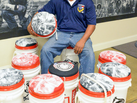 Gikus Bigelow, a member of L-456, sits among tool buckets he donated to contestants in the 2015 National Apprenticeship Competition. 