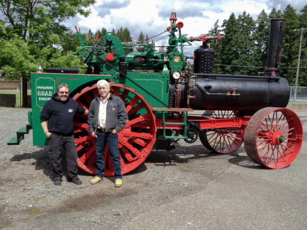 Barry Dobrensky, left, and Mike Roxburgh stand alongside the 1917 Farquhar tractor they helped restore.