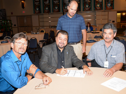 Signing real estate documents for a new training center to be built in Salt Lake City are, l. to. r., Jim Cooksey, AIP/IR-CSO, WSJAC Trustee; J. Tom Baca, IVP-WS, WSJAC Secretary; Collin Keisling, WSJAC Coordinator; and Larry Jansen, ARB Vice President and WSJAC Chairman.