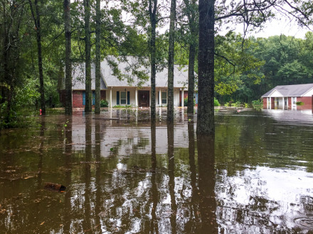 Anthony Howell’s home, left, during the August 2016 flood.