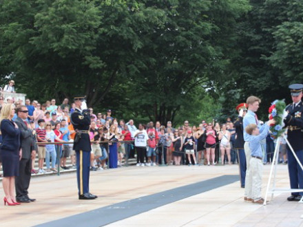 Bridget Martin and her husband, Bryan, watch as their sons, Bryce and Brody, receive the wreath prior to setting it at the tomb.