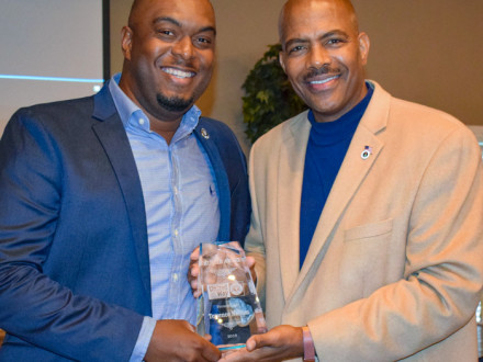Local 693’s Terrence Nellum, left, receives the Hustle Award from Tee McCovey, public relations director for the Mississippi United Way for Jackson and George Counties.