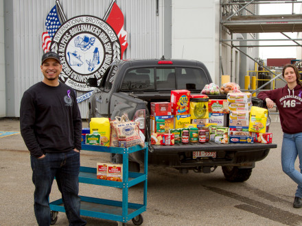 Boilermakers Calgary Rep Steve Warren and Pre-Apprentice Instructor Kayla Vander Molen collect non-perishable donations at the L-146 Calgary hall for a local Calgary food bank.