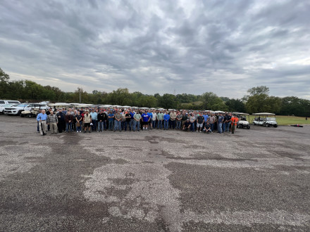 Before loading up on golf carts, 138 participants pose for a commemorative photo.