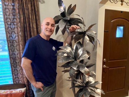 Boilermaker and artist Scott Griffin stands with one of his many flower creations. 