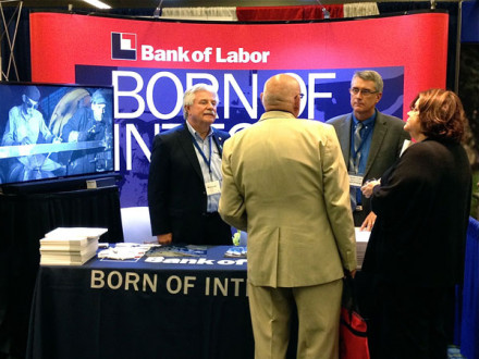 Tom Johnson (l.) and Randy Cruse, representing the Bank of Labor, provide information to delegates attending the Building and Construction Trades Department Legislative Conference in Washington, D.C., April 30.