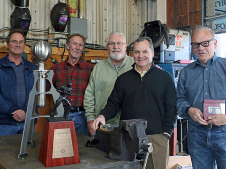 Boilermakers present Ian MacGregor, far right, with an honorary membership and a replica of Hero’s steam engine. L. to r.: Dean Milton, L-146 BM-ST; Charles Jones, D-BHPD; Joe Maloney, IVP-Canada; Warren Fairley, IVP-SE; and MacGregor.
