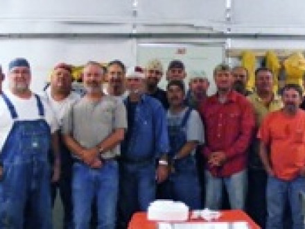 While working on a scrubber project at the J.H. Miller Steam Plant in Quinton, Ala., Local 108 members receive membership pins representing 465 years of service during a party honoring retiring 34-year member Charles W. Ferguson III June 11.