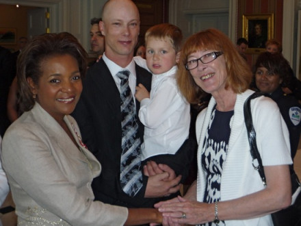 Governor General of Canada Michaëlle Jean (l.) greets L-146 member Mack Walker and his family after presenting him with the Canadian Medal of Bravery.