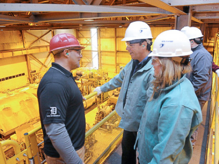 Wertz, left, talks with Reps. Kosowski and Roberts on a gallery overlooking the plant’s Unit 2 turbine and generator.