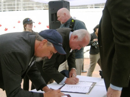 L-359 BM-ST Phil Halley, left, joins 15 other Canadian labor unions in signing a project labor agreement to modernize the Rio Tinto Alcan aluminum plant in Kitimat, British Columbia.