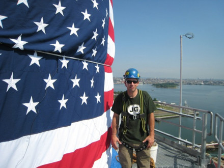 While his father, L-5 shop steward George Lonergan, gives a 9-11 memorial address, L-5’s Brian Lonergan presents the colors on a 300-foot stack at a job site at the New York Harbor in Astoria, N.Y.