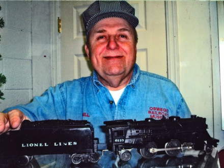 Bill Nickolas displays the locomotive and coal car from his 1950 Scout Lionel train set.