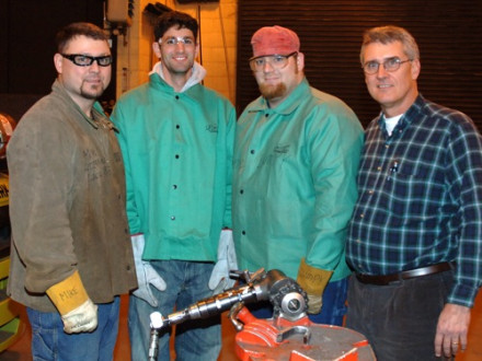 Career-seeker Daniel Seddiqui, second from left, gets some first-hand experience with a tube beveling machine at Local 83 in Kansas City, Mo. From left are welding instructor Mike Anderson, Seddiqui, welding instructor Clayton “Lumpy” Knepp, and BM-ST Randy Cruse.