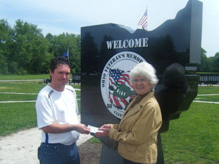L-900 President Don Hamric stands with Chell Rossi, vice president of the Ohio Vietnam Veterans Memorial Park, in front of the marble welcome sign purchased with funds from the local and a donation from the International.