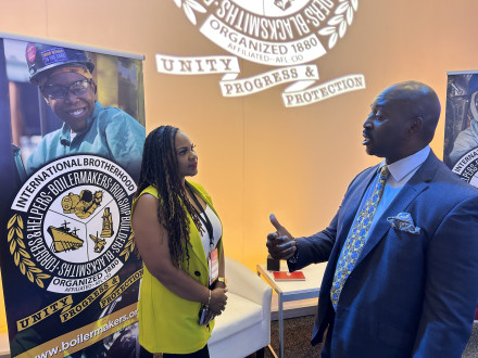 Erica Stewart talks with a visitor to the Boilermakers booth at the NAACP Convention career fair.