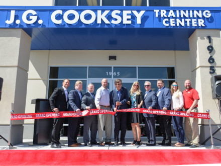 Jim Cooksey cuts the ceremonial red ribbon to signify the center’s official opening. l. to r. WSJAC Assistant Coordinator Andrew Jones, BOL President Bob McCall, SBCTC President Robbie Hunter, WSJAC Area Coordinator Collin Keisling, Cooksey, Charmayne Cooksey, IP Newton Jones, IVP Tom Baca, and Jenny Farney and Dan Klingman of Lincoln Electric.