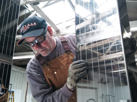 Jim Stapf, L-106, installs a stainless steel replica of the World Trade Center’s twin towers on the 911 Steel traveling memorial. Photo courtesy of Fred Anderson
