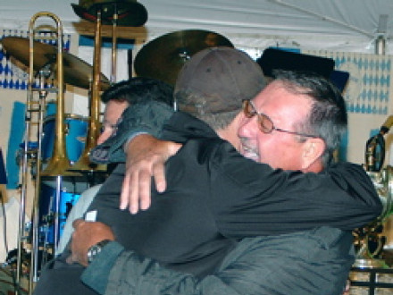 Retired AIP Bill Carey gets a big hug from son Scott upon winning a new Grady-White fishing boat.