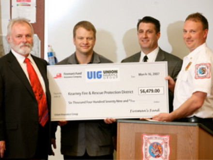 IST Bill Creeden, left, joins in a check presentation to the Kearny, Mo., Fire Protection District. L. to r. are Chris DeCaigny, president of the Union Insurance Group; Rick Victores, field vice president for Fireman’s Fund Insurance; and Captain Kevin Pratt of the Kearny FPD.