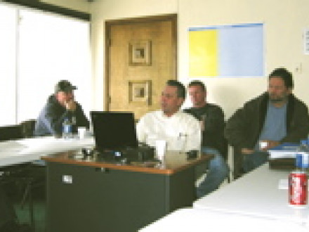 Intl. Rep Len Gunderson (center with laptop) conducts a training program for Local S8 members. Consultant Mike Murphy is pictured second from left.
