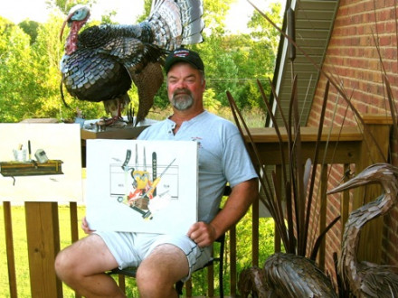 L-40 retiree Frank Linton displays two of his paintings and samples of his metal art — a life-size turkey and sculpture of Blue Heron.