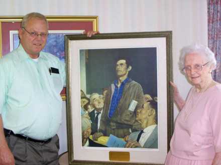 Mrs. Marie B. McDonough presents a framed copy of Norman Rockwell’s “Freedom of Speech” print to L-1 BM-ST John Skermont.