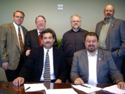 Signing a three-year agreement for the Western States Area are, l. to r., seated: chairmen Larry Jansen (employer) and Tom Baca (union); standing, employer co-chairman Jerry Bennett and secretary Tom Dillon, and union secretary David Bunch and co-chairman Kyle Evenson.
