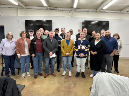 State Legislative Coordinator Bill Mulconnery, front row, fourth from left, stands with Congresswoman Nikki Budzinski (IL-13), fourth from right. Mulconnery and other local union leaders met in February with Budzinki, who serves on important congressional committees including the Congressional Building Trades Caucus, Congressional Apprenticeship Caucus, Congressional Career and Technical Education Caucus, Veterans Affairs Committee and the Sustainable Energy and Environment Coalition.