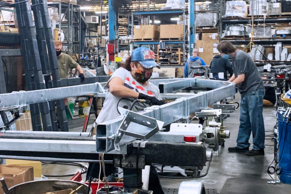 Boilermakers Maria Zuniga and Thomas Kinn assemble a trailer frame.