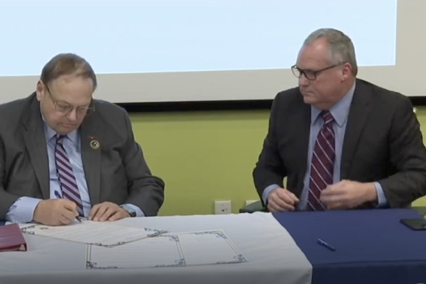 Bartlett Maritime Founder and CEO Edward L. Bartlett, Jr., left, and IP Warren Fairley sign the agreement.