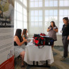 Conference participants chat at one of the booths set up at the health fair adjacent to the Canadian tripartite.